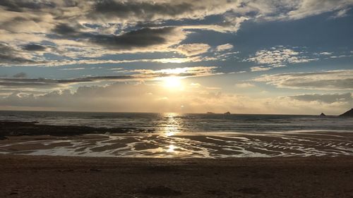 Scenic view of beach against sky during sunset