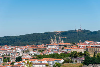 High angle view of buildings against clear blue sky