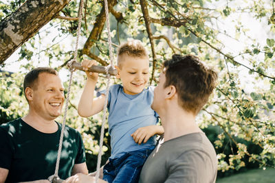 Happy friends against plants and trees