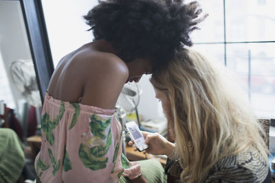 A young couple looking at a smart phone