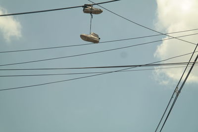 Low angle view of cables against sky