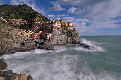 Scenic view of sea and buildings against sky