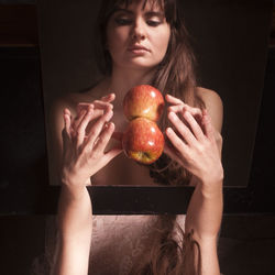 Midsection of woman holding apple