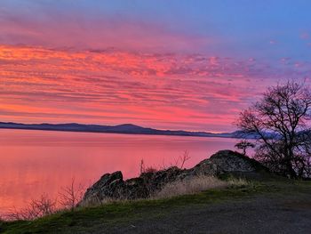 Scenic view of lake against sky during sunset