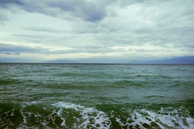 Scenic view of sea against cloudy sky