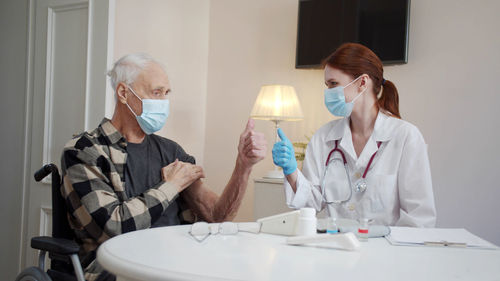 Female doctor examining patient at clinic