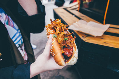 Midsection of woman holding street food