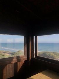 Scenic view of sea seen through glass window