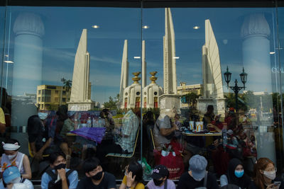 Group of people in temple against sky