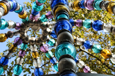 Low angle view of decorations hanging against tree