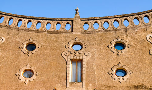 Low angle view of building against clear blue sky