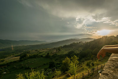 Low section of person on landscape against sky