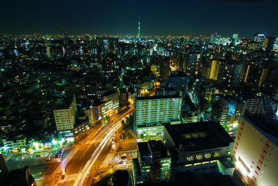 High angle view of illuminated city buildings at night