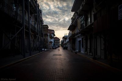 Buildings in city against cloudy sky