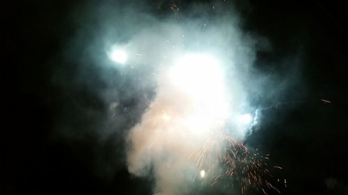 Low angle view of illuminated lights at night