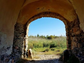 Abandoned built structure on field against clear sky