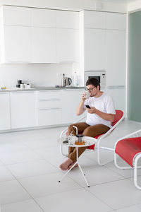 Young man sitting on sofa at home