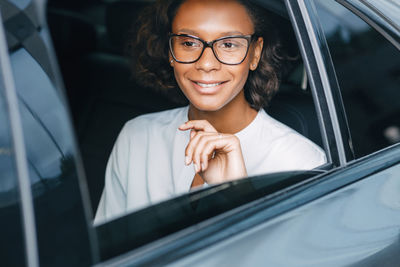 Portrait of a smiling young woman in car