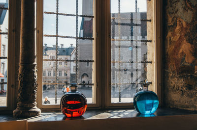 Close-up of bottles of window sill