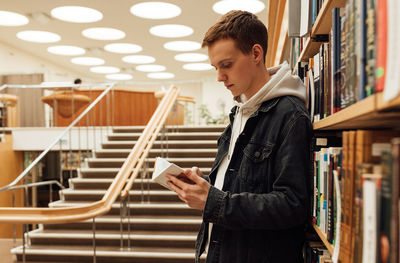 Side view of man using mobile phone