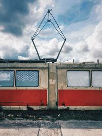 Railroad track against cloudy sky