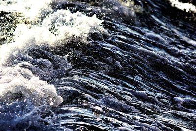 Close-up of wave splashing on rock