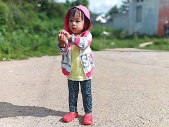 Full length of cute girl standing outdoors