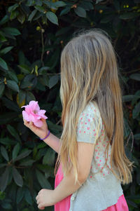 Rear view of a girl with pink flower