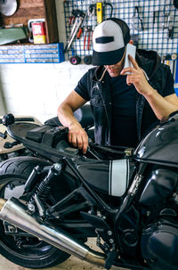Mechanic with motorcycle at garage