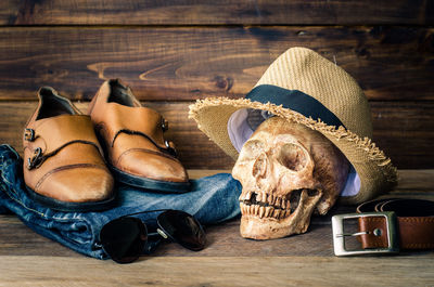Close-up of human skull with fashion accessories on table