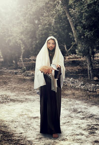 Full length of a man standing in a forest