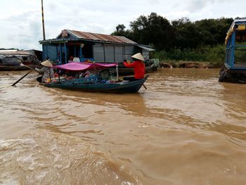 Boat moored on river against sky