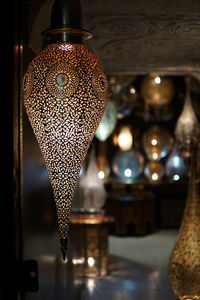 Close-up of illuminated lantern hanging for sale in store