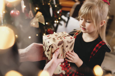 Full length of girl holding hands in box