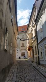 Empty alley amidst buildings in town