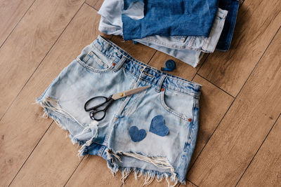 High angle view of personal accessories on hardwood floor