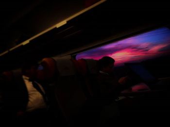 Blurred motion of woman in dark room