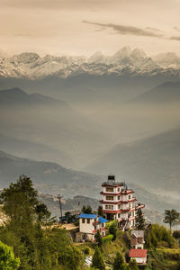 Town by mountains against sky