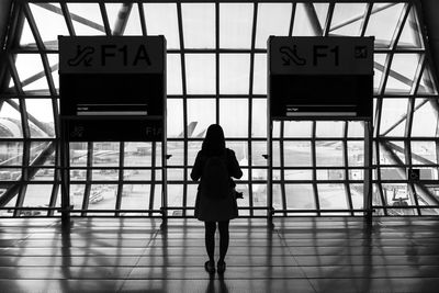 Rear view of woman standing at airport