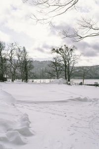 Scenic view of snow covered field against sky