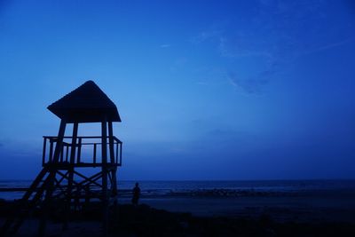 Lifeguard hut on beach against sky