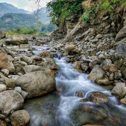 Scenic view of waterfall against sky