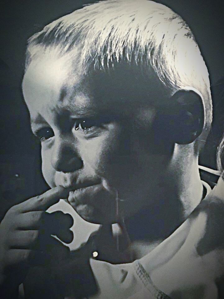 CLOSE-UP OF MAN WITH STATUE