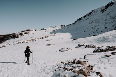 People skiing on snow covered mountain