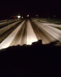 Road passing through illuminated tunnel