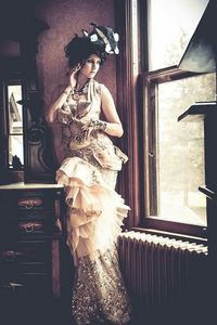 Portrait of young woman standing by window