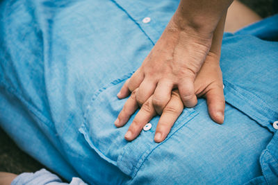 Close-up of hands on blue finger