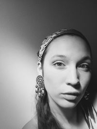 Close-up portrait of young woman against white background
