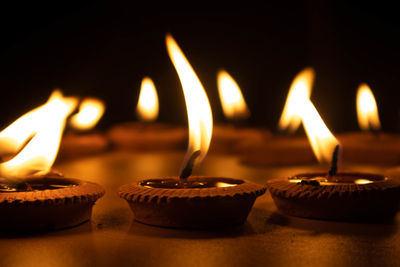 Close-up of illuminated candles on table