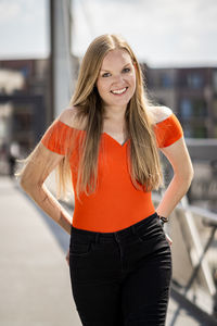 Portrait of a smiling young woman standing outdoors